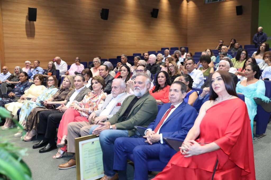 Audiencia sentada en una sala de conferencias asiste a un evento.