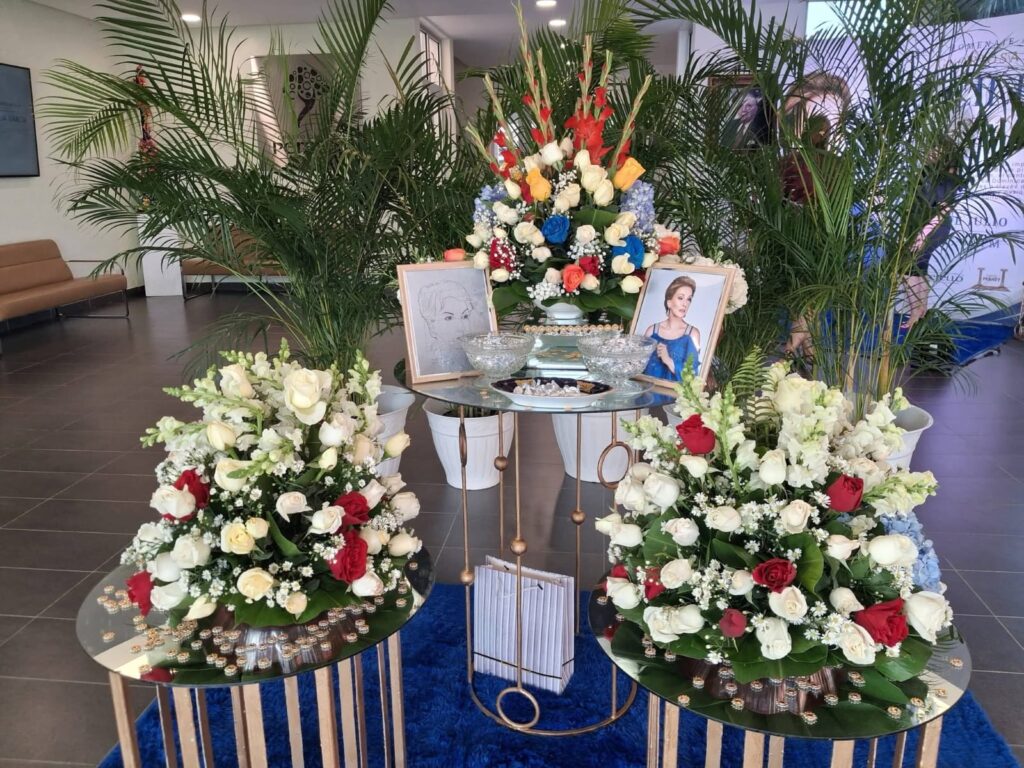 Mesa de homenaje con flores, fotos y recuerdos