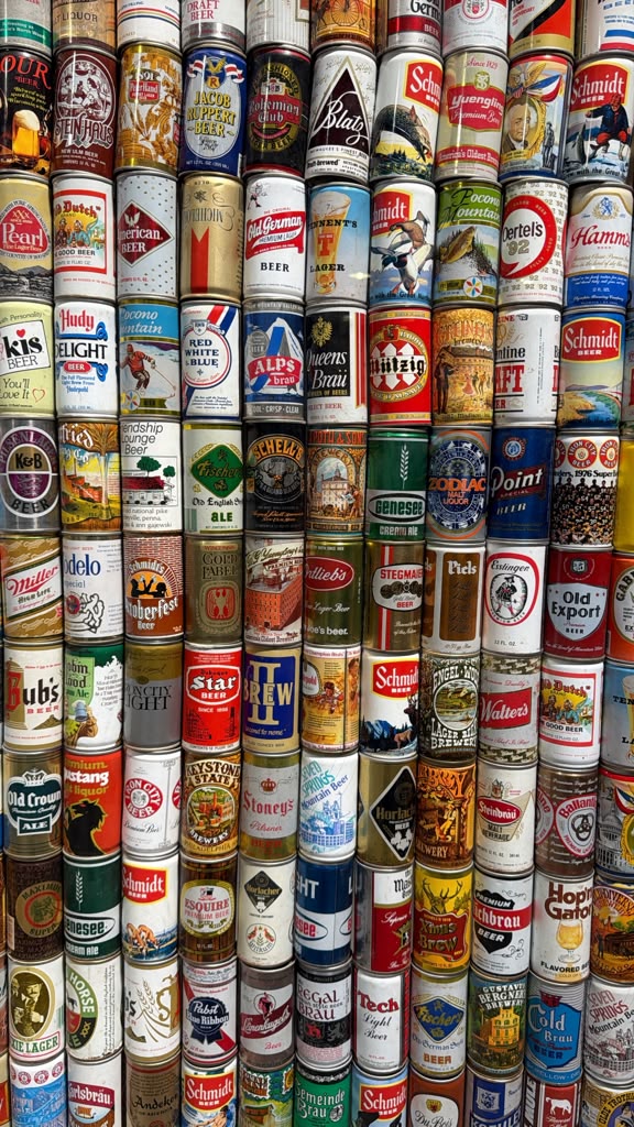 Pila de latas de cerveza variadas y coloridas.