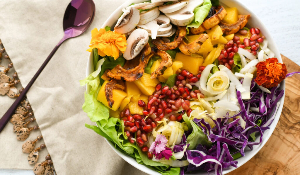 Ensalada colorida y vibrante con frutas y verduras frescas.